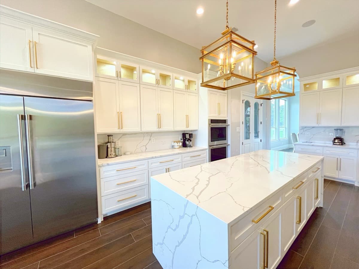 Crafted Kitchens project with white cabinetry and brass lantern pendants